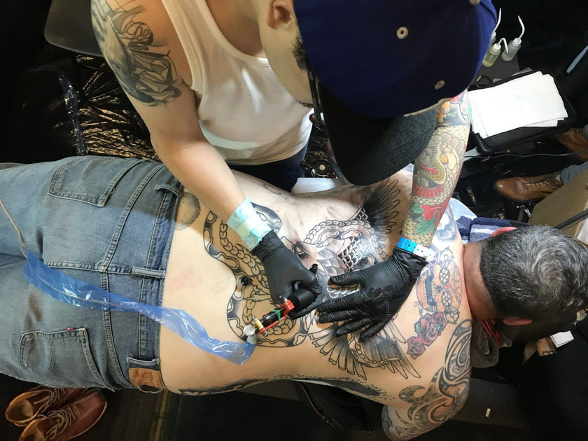 Gabe Tattoos from No Idols NYC working on back tattoo